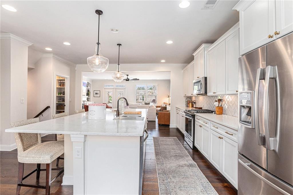 1438 Druid Manor Boulevard Atlanta, GA 30329 - Photo 6 of 31 a large kitchen with stainless steel appliances kitchen island granite countertop a sink and a refrigerator