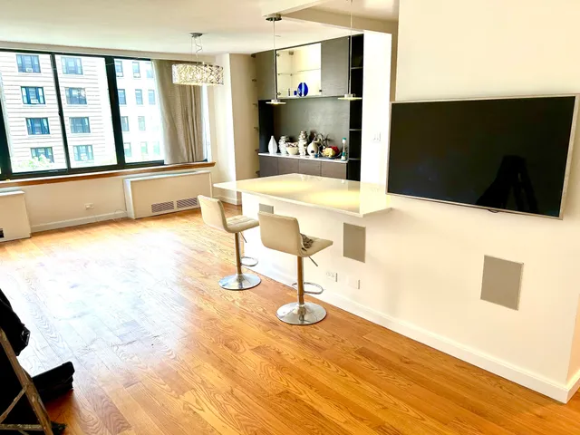 a view of a living room with furniture and a flat screen tv