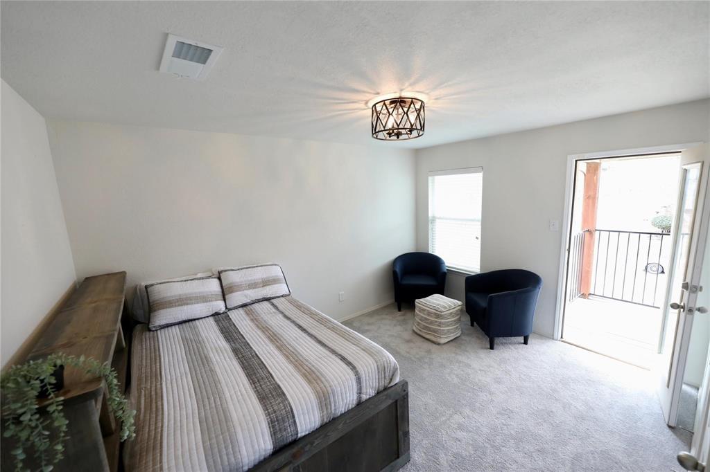 8404 Timberbrook Lane Dallas, TX 75249 - Photo 13 of 32 a bedroom with a bed and a large window