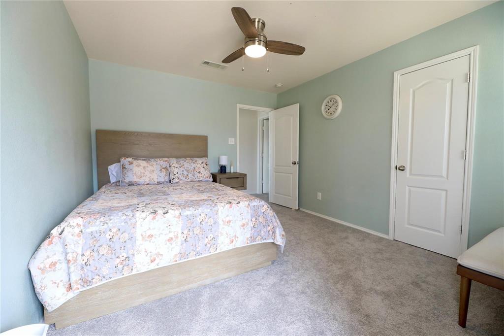 8404 Timberbrook Lane Dallas, TX 75249 - Photo 14 of 32 a bedroom with a bed and a chandelier