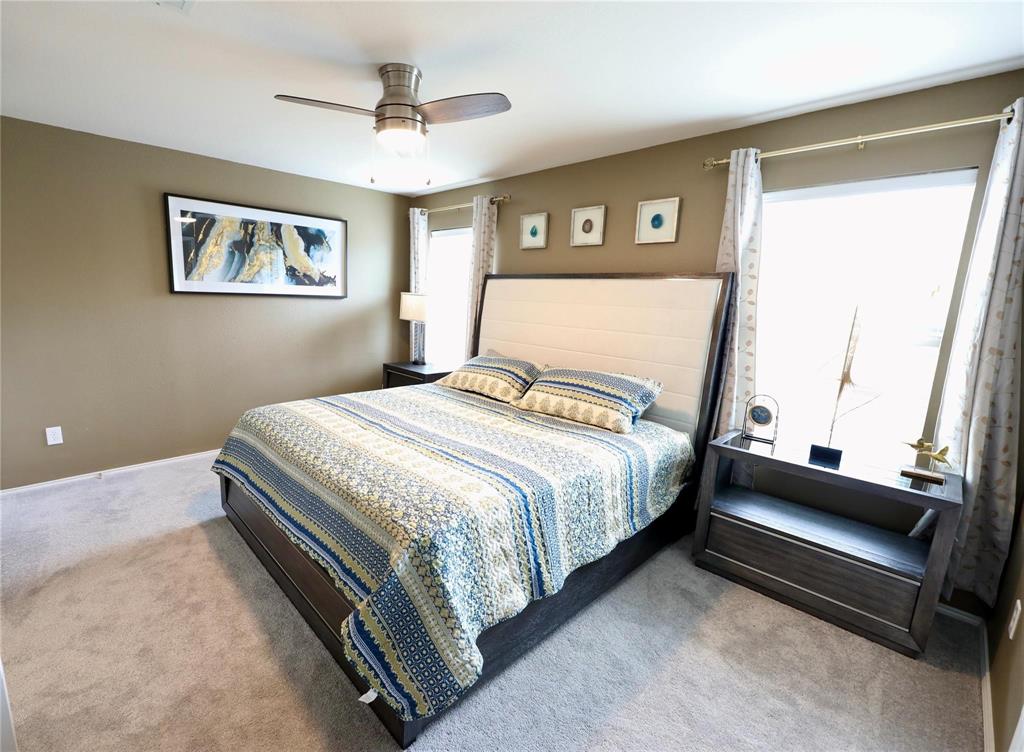 8404 Timberbrook Lane Dallas, TX 75249 - Photo 19 of 32 a bedroom with a bed and a window