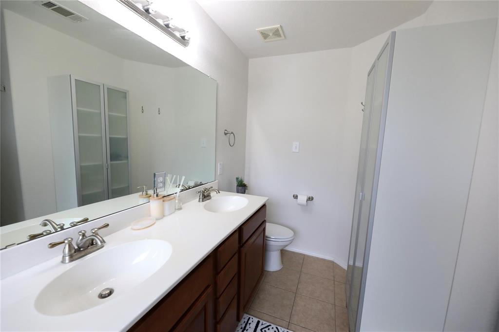 8404 Timberbrook Lane Dallas, TX 75249 - Photo 24 of 32 a bathroom with a sink and a mirror