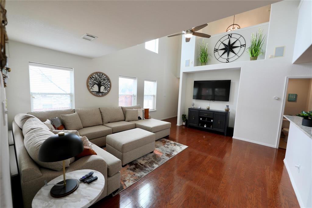 8404 Timberbrook Lane Dallas, TX 75249 - Photo 3 of 32 a living room with furniture and a flat screen tv