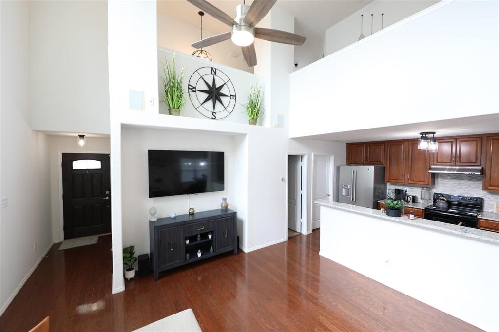 8404 Timberbrook Lane Dallas, TX 75249 - Photo 31 of 32 a living room with furniture and a flat screen tv