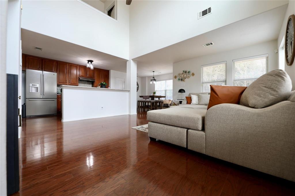 8404 Timberbrook Lane Dallas, TX 75249 - Photo 4 of 32 a bedroom with a bed and a refrigerator