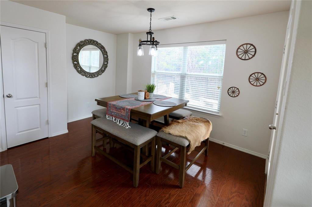 8404 Timberbrook Lane Dallas, TX 75249 - Photo 5 of 32 a view of a dining room with furniture window and wooden floor