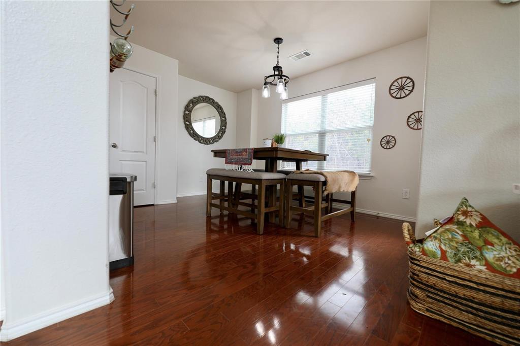 8404 Timberbrook Lane Dallas, TX 75249 - Photo 8 of 32 a view of a dining room with furniture and wooden floor