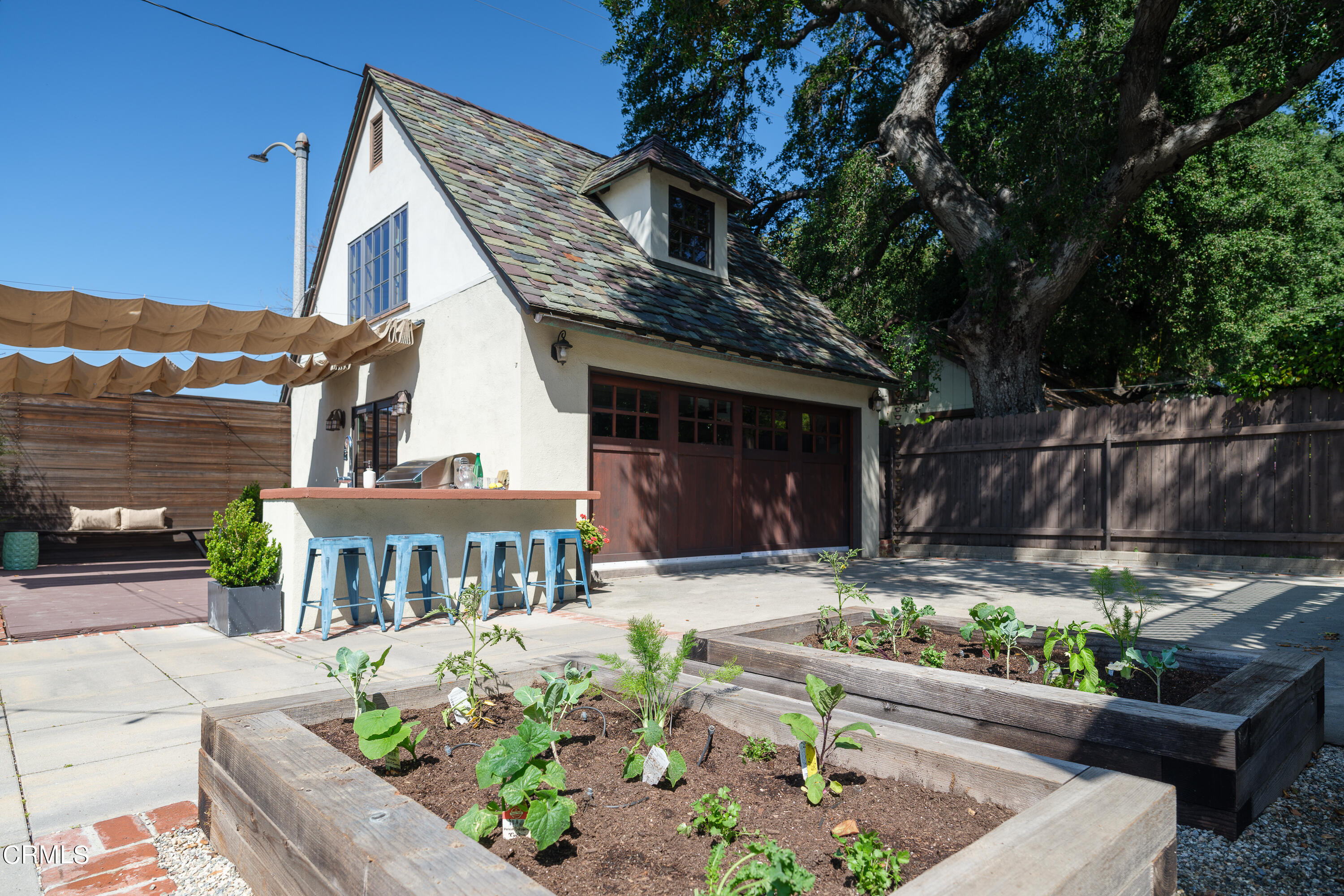 2295 Norwic Place Altadena, CA 91001 - Photo 47 of 60 a house with lots of potted plants and a bench