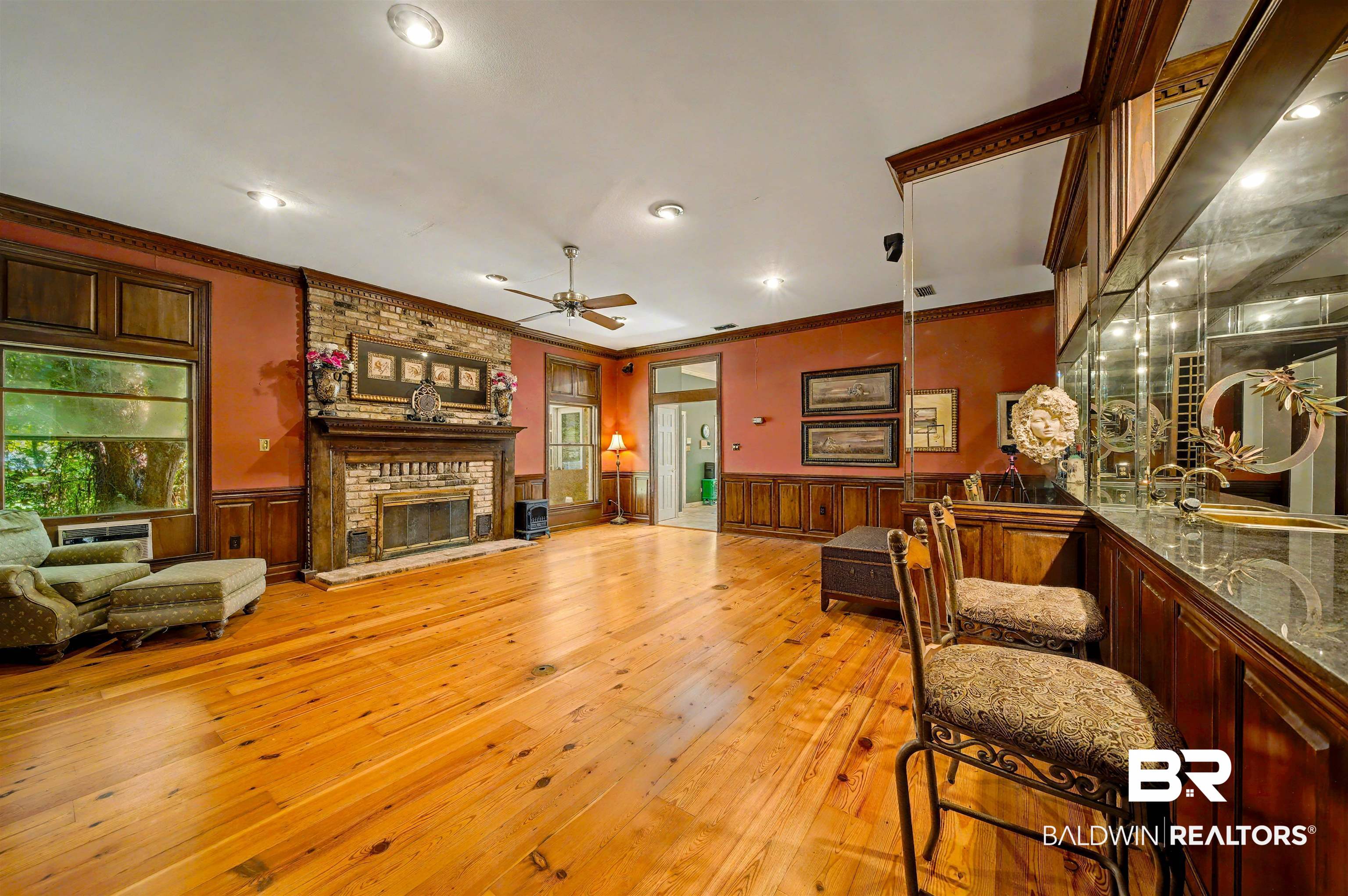 15810 County Road 73 Foley, AL 36535 - Photo 13 of 56 Living area featuring ornamental molding, light wood finished floors, wainscoting, a fireplace, and a dry bar