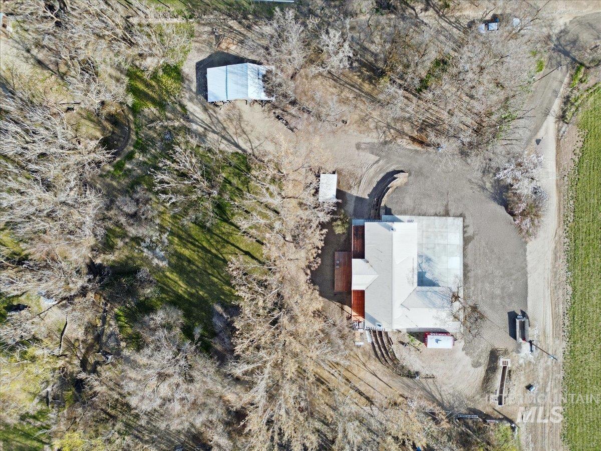 7771 Elmore Road Fruitland, ID 83619 - Photo 47 of 48 Aerial perspective showcasing a single-story residence with a light-colored roof