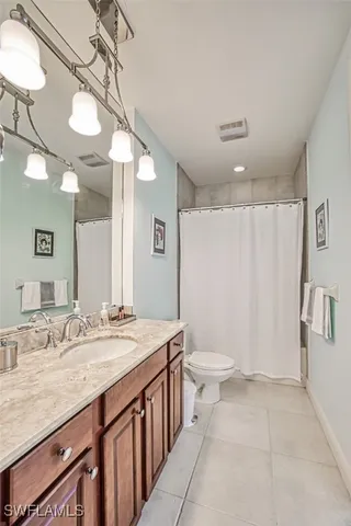 a bathroom with a double vanity sink and a toilet