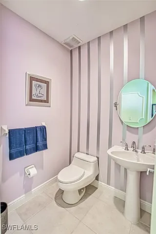 a bathroom with a toilet a sink and a mirror