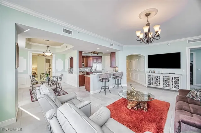 a living room with furniture dining table and a flat screen tv