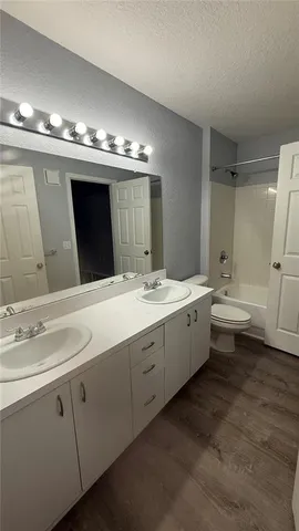 a bathroom with a double vanity sink and a mirror
