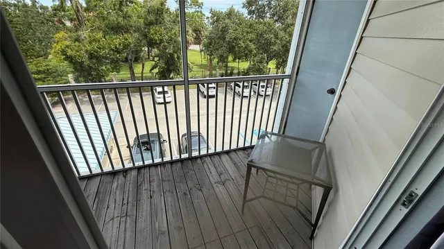 a view of balcony with wooden floor