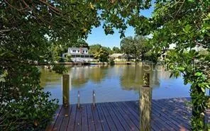a view of a lake with couches and wooden floor
