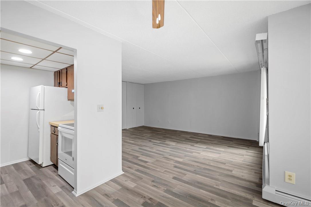 150 Overlook Avenue, Unit 2K Peekskill, NY 10566 - Photo 6 of 26 a view of empty room with wooden floor and kitchen