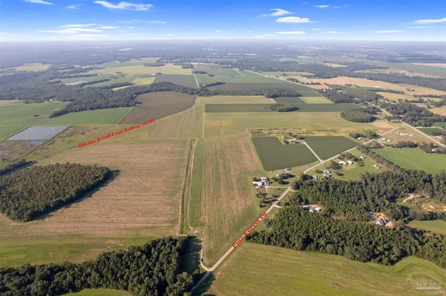 a view of a field with an ocean