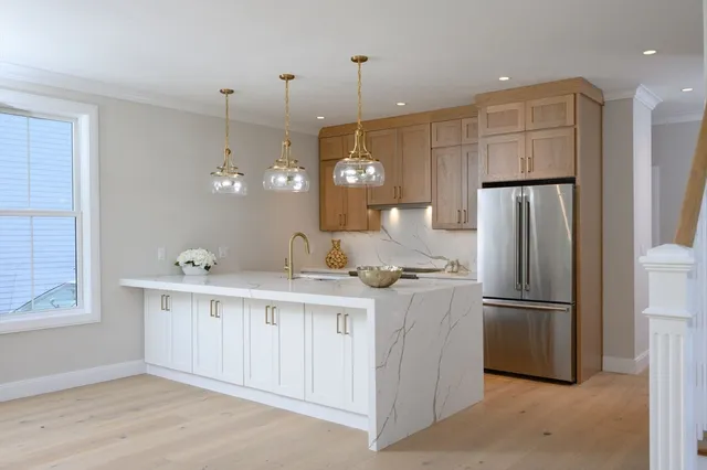 a view of a kitchen with wooden floor and stairs