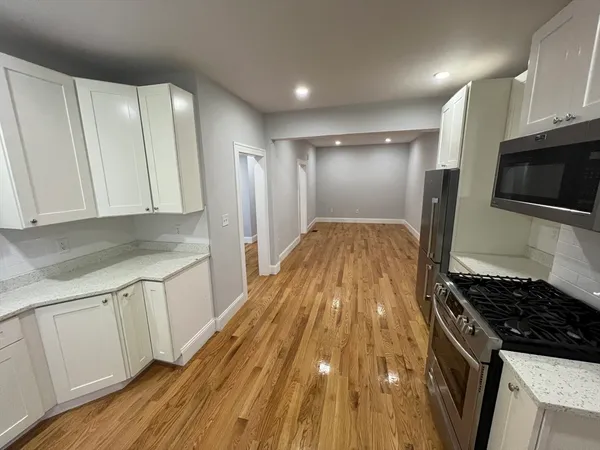 a kitchen with granite countertop a sink and a stove top oven
