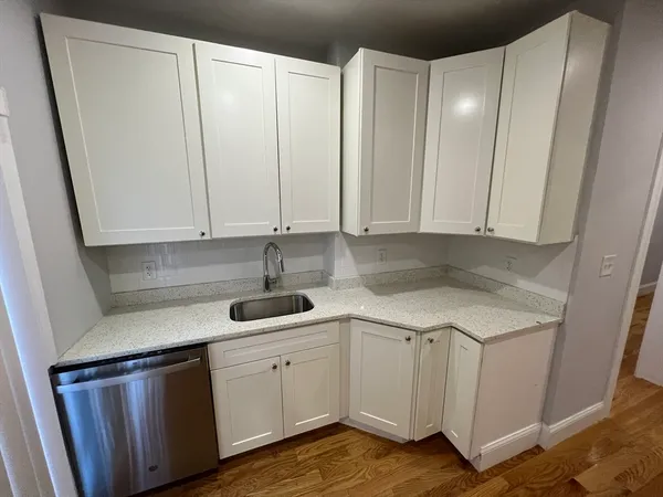 a kitchen with a sink cabinets and appliances