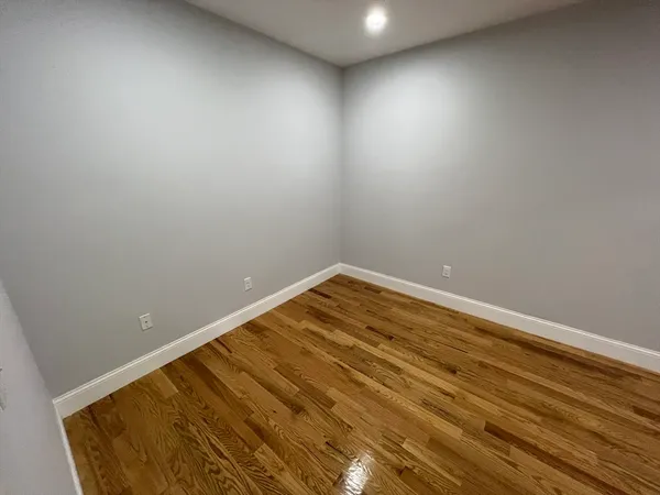a room with wooden floor and natural light