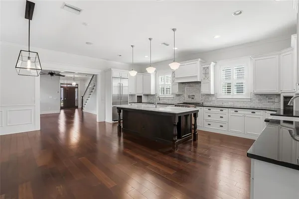 a kitchen with granite countertop white cabinets and white appliances