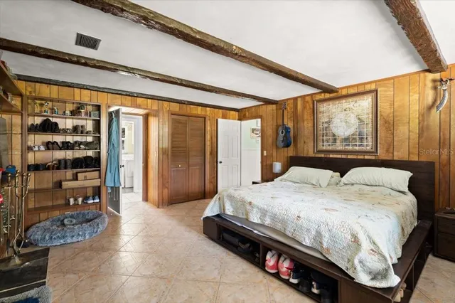 a bedroom with a large bed and a large window