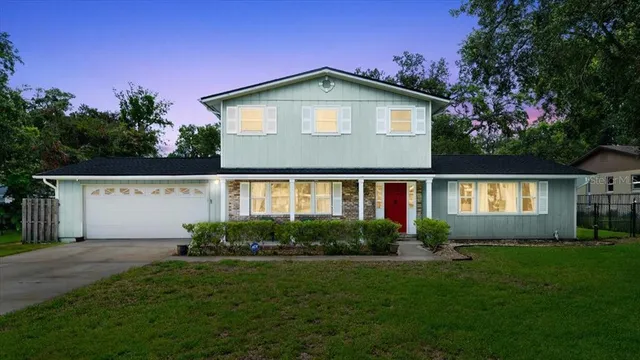 a front view of a house with a garden and plants