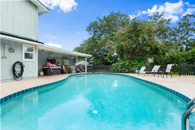 a backyard of a house with table and chairs