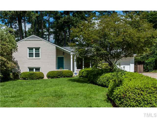 912 Macon Place Raleigh, NC 27609 - Photo 1 of 14 a backyard of a house with plants and large tree