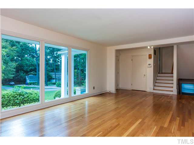 912 Macon Place Raleigh, NC 27609 - Photo 2 of 14 a view of an empty room with wooden floor and windows