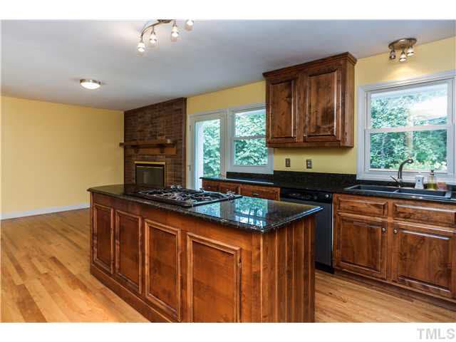 912 Macon Place Raleigh, NC 27609 - Photo 4 of 14 a kitchen with stainless steel appliances granite countertop a stove a sink and a microwave