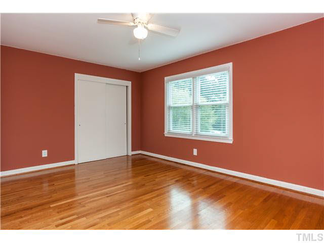 912 Macon Place Raleigh, NC 27609 - Photo 5 of 14 an empty room with wooden floor and windows