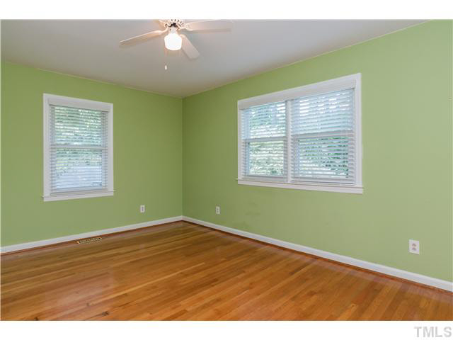 912 Macon Place Raleigh, NC 27609 - Photo 7 of 14 a view of an empty room with wooden floor and a window