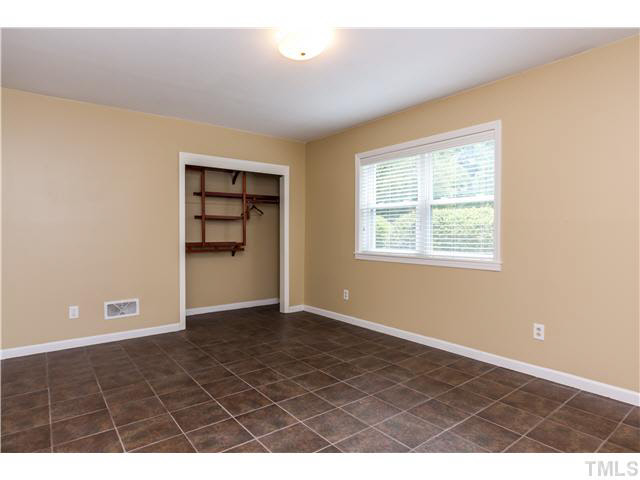 912 Macon Place Raleigh, NC 27609 - Photo 8 of 14 a view of an empty room with closet and window
