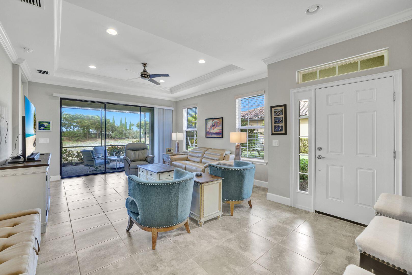 a dining room with furniture and large windows
