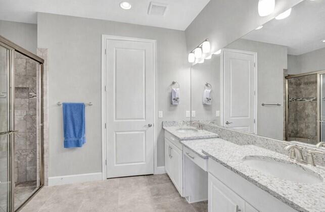 8581 Maggiore Court Naples, FL 34114 - Photo 11 of 33 a bathroom with a granite countertop sink and a mirror