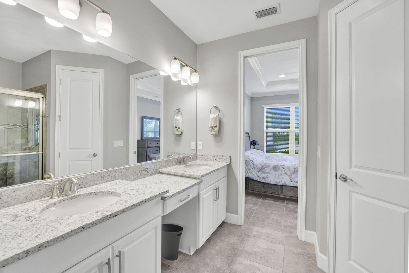 8581 Maggiore Court Naples, FL 34114 - Photo 12 of 33 a en suite bathroom with a granite countertop double vanity and a mirror