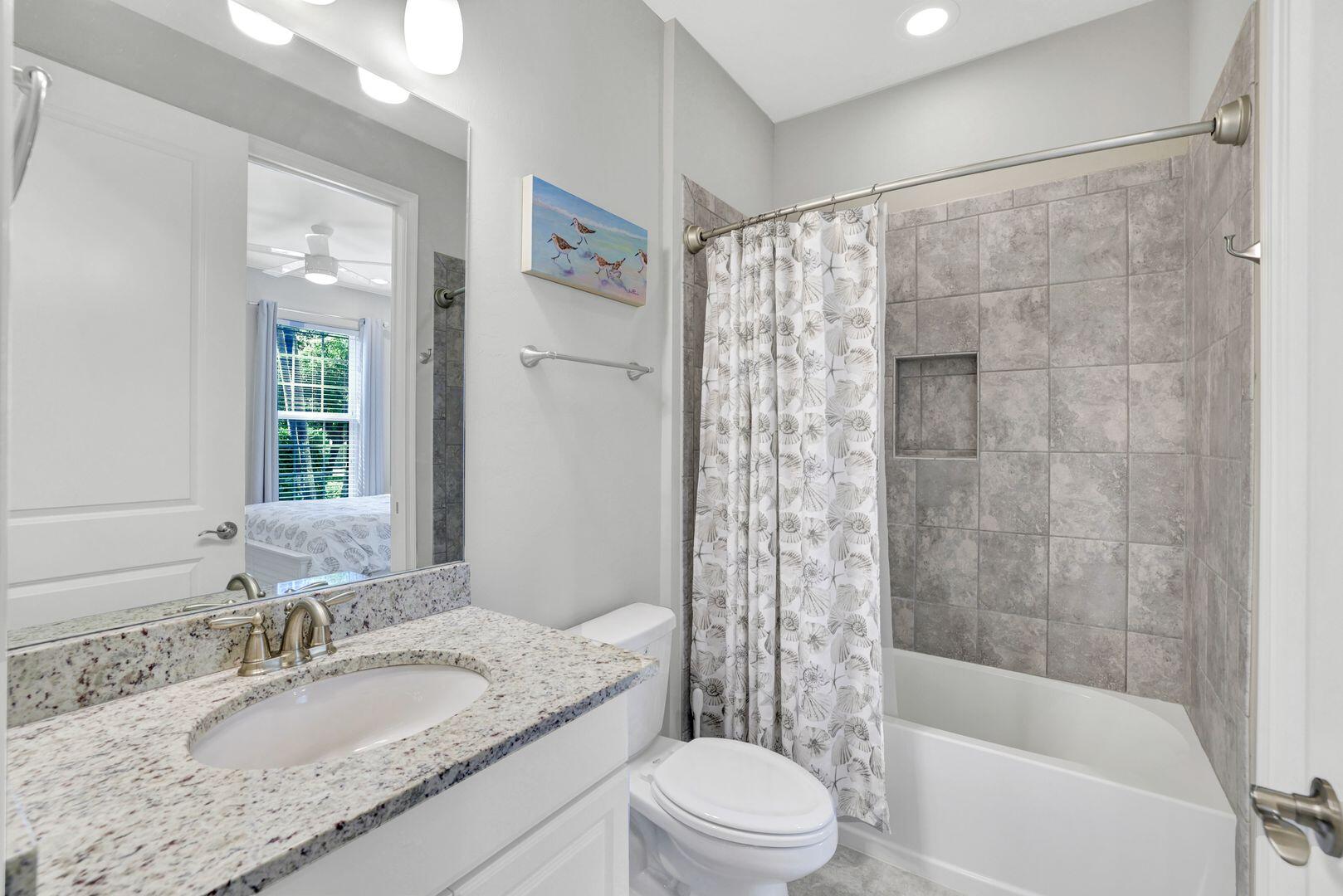 8581 Maggiore Court Naples, FL 34114 - Photo 14 of 33 a bathroom with a granite countertop sink toilet and shower
