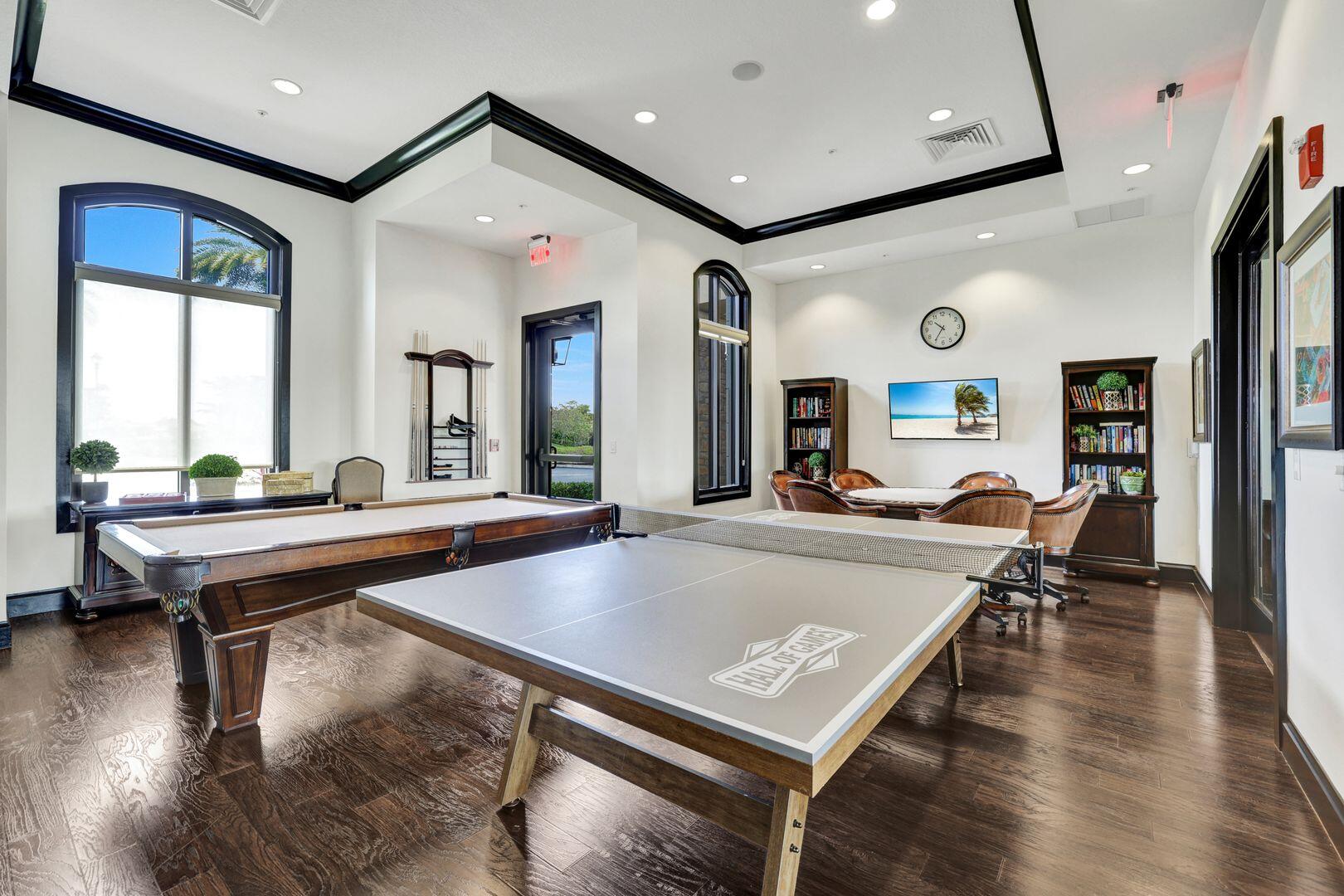 8581 Maggiore Court Naples, FL 34114 - Photo 16 of 33 a living room with table a pool table and a large window