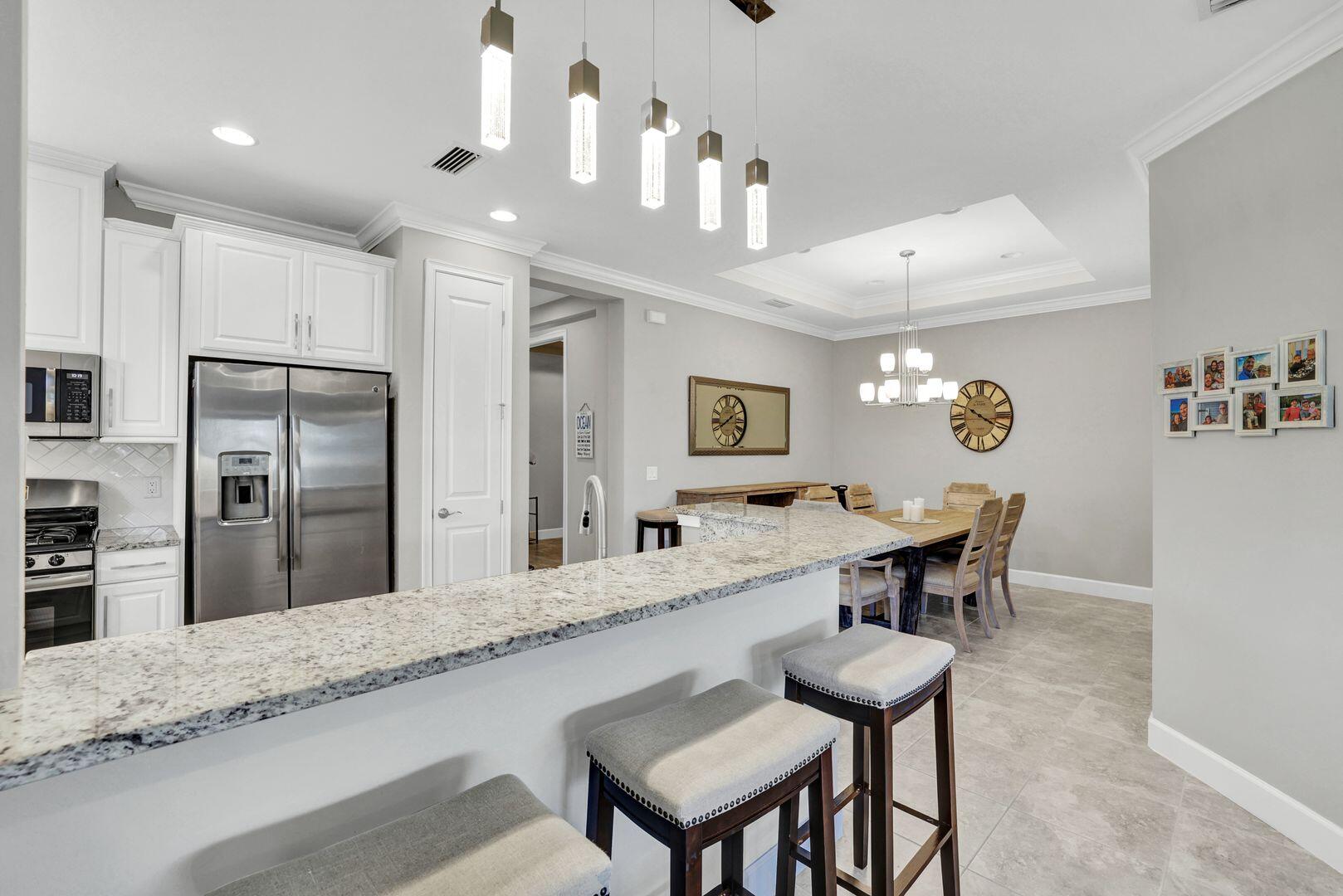 8581 Maggiore Court Naples, FL 34114 - Photo 9 of 33 a large kitchen with granite countertop lots of counter space and refrigerator