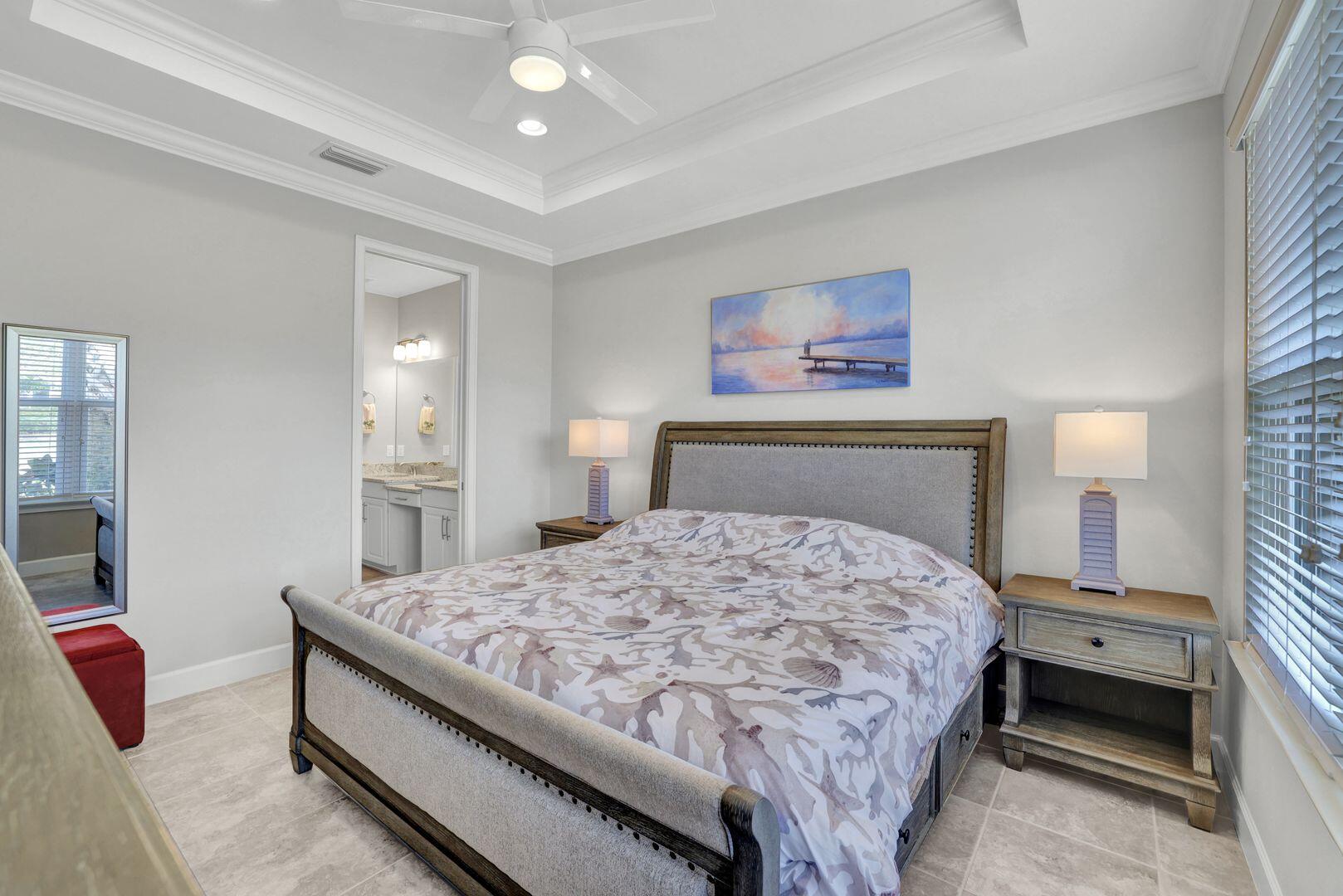 8581 Maggiore Court Naples, FL 34114 - Photo 10 of 33 a bedroom with a bed and a chandelier