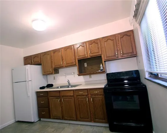 a kitchen with granite countertop a refrigerator stove and microwave
