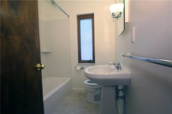 a bathroom with a sink a toilet and tub
