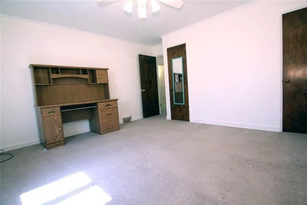 a view of an empty room with a fireplace