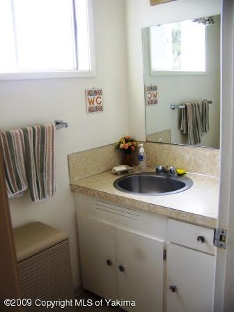 168002 McCreadie Road Grandview, WA 98930 - Photo 13 of 34 a bathroom with a sink and a mirror