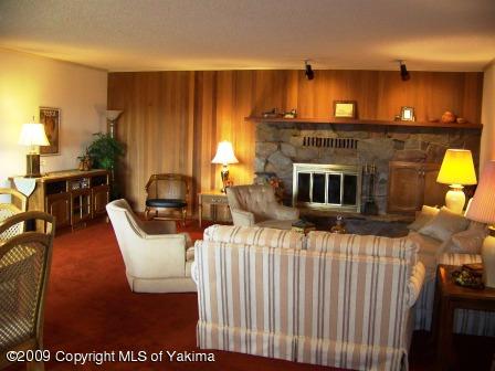 168002 McCreadie Road Grandview, WA 98930 - Photo 17 of 34 a living room with furniture a fireplace and a dining table with wooden floor