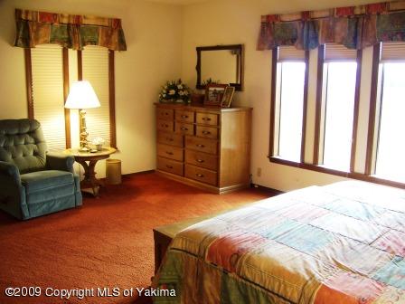 168002 McCreadie Road Grandview, WA 98930 - Photo 19 of 34 a bedroom with a bed and wooden floor