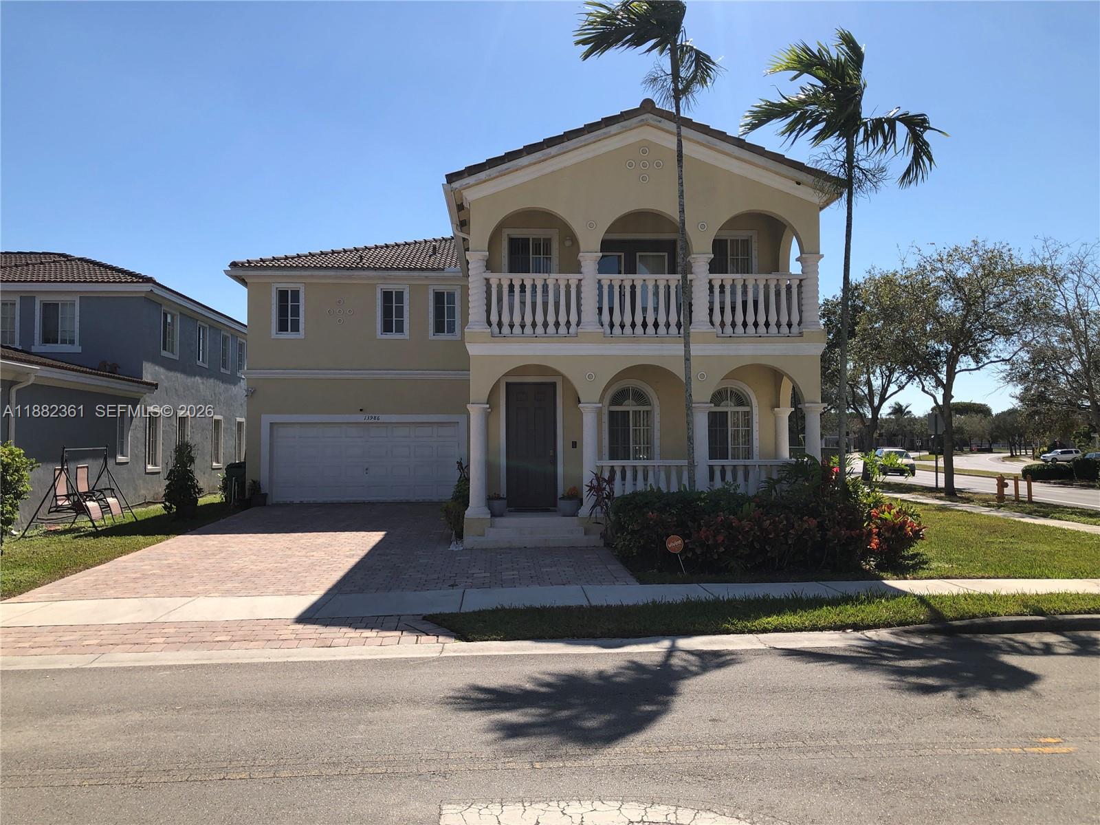 13986 Southwest 276th Way Homestead, FL 33032 - Photo 1 of 32 a front view of a house with a yard